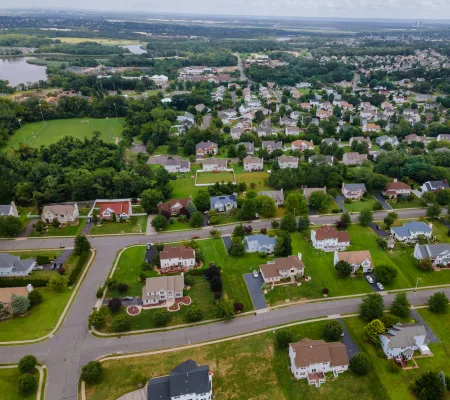 Aerial view of a suburban neighborhood with tree-lined streets